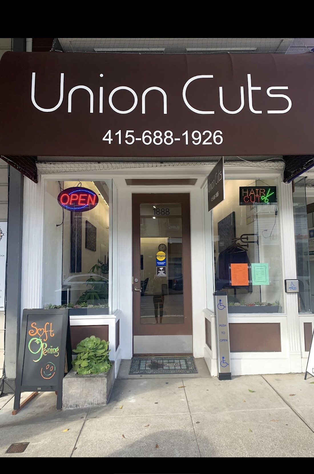 Union Cuts storefront at 1888 Union St — awning with phone number, OPEN sign, and entrance